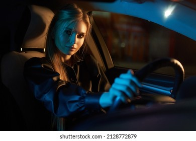 Beautiful Young Woman Driving Car At Night