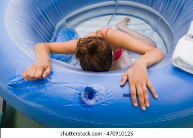 Beautiful Young Woman During Labour, Having Painful Cramps, Giving Birth In Water.