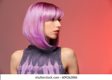 Beautiful young woman and dyed hair color background