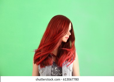 Beautiful young woman and dyed hair color background