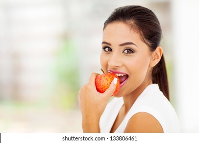 Beautiful Young Woman Eating An Apple