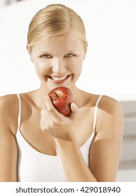 beautiful young woman eating an apple