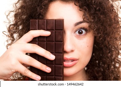 Beautiful Young Woman Eating A Chocolate Bar