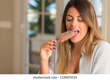 Beautiful Young Woman Eating Ice Cream With Pleasure Face At Home. Lifestyle Concept.