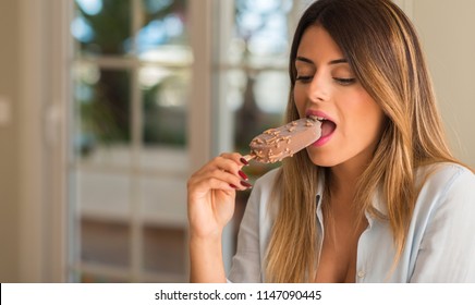 Beautiful Young Woman Eating Ice Cream With Pleasure Face At Home. Lifestyle Concept.