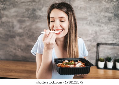 Beautiful young woman eating Italian pasta.