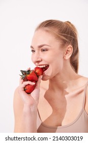 Beautiful Young Woman Eating Juicy Fruits