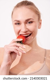 Beautiful Young Woman Eating Juicy Fruits