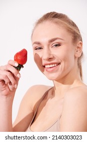 Beautiful Young Woman Eating Juicy Fruits