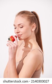 Beautiful Young Woman Eating Juicy Fruits