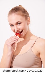 Beautiful Young Woman Eating Juicy Fruits