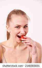 Beautiful Young Woman Eating Juicy Fruits