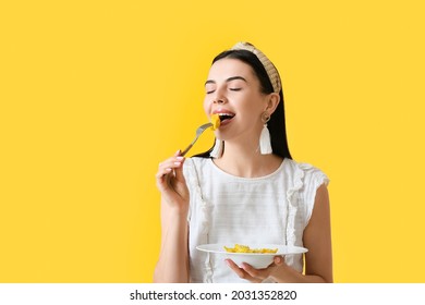 Beautiful Young Woman Eating Tasty Ravioli On Color Background