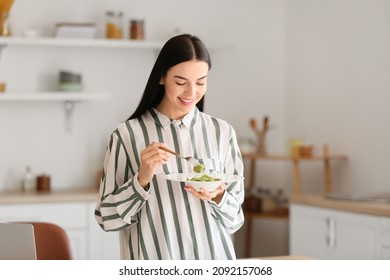 Beautiful Young Woman Eating Tasty Ravioli At Home