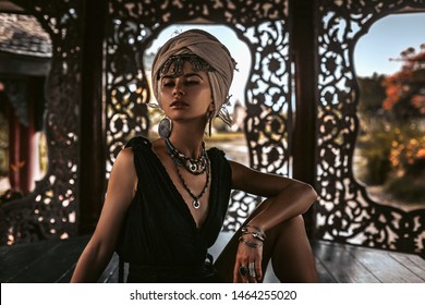 Beautiful Young Woman In Elegant Black Dress Wearing Turban. Oriental Princess