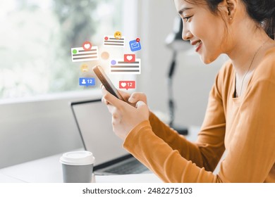 Beautiful young woman enjoy with social media on mobile phone with notification icons of like, message, comment above smartphone screen. - Powered by Shutterstock