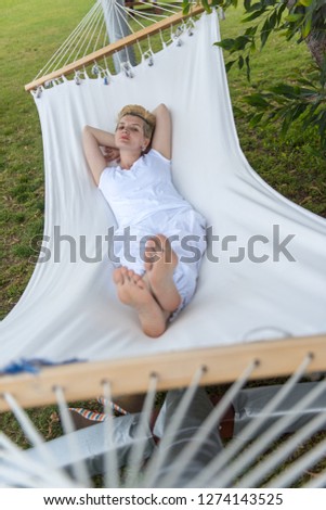 Similar – Young woman relaxing in a hammok