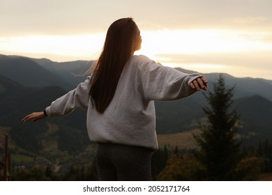 Beautiful young woman enjoying her time in mountains