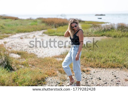 Similar – Young woman standing with closed eyes at the Baltic Sea beach