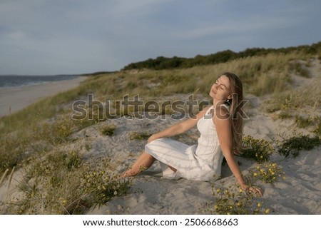 Similar – Young woman on the beach in the sun