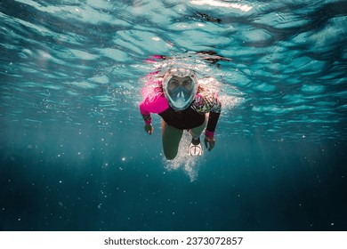 beautiful young woman enjoys snorkeling in the indian ocean. active holiday in the Maldives. - Powered by Shutterstock