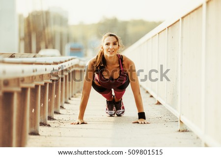 Similar – Young woman stretching arms before training outdoors