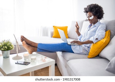 Beautiful Young Woman With Eye Mask On Her Face Having Video Call, Looking At Laptop Computer And Talking To Her Friends Via Video Call.  Skin Care And Treatment, Spa, Natural Beauty And Cosmetology 