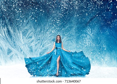 Beautiful young woman in fairy tale forest with long luxurious dress