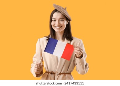 Beautiful young woman with flag of France on yellow background - Powered by Shutterstock