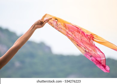 Beautiful Young Woman With Flying Scarf On Beach,Carefree Girl Seaside Holding Scarf Fluttering In The Wind.
