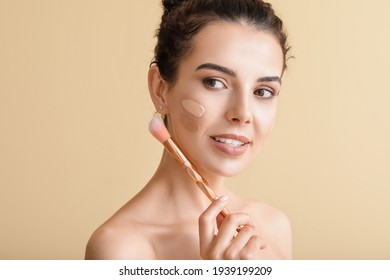 Beautiful young woman with foundation on her face against color background - Shutterstock ID 1939199209