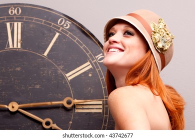 Beautiful Young Woman In Front Of An Antique Clock