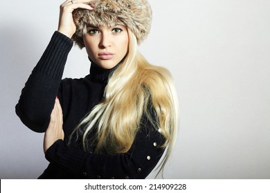 Beautiful Young Woman in Fur Hat. Pretty Blond Girl. Winter Fashion Beauty.Healthy hair