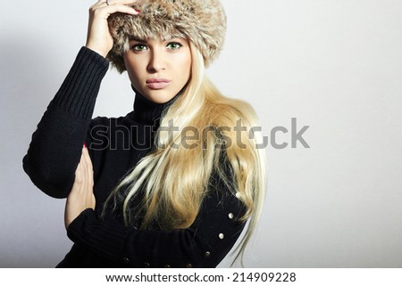 Beautiful Young Woman in Fur Hat. Pretty Blond Girl. Winter Fashion Beauty.Healthy hair