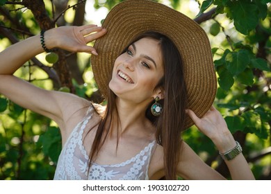 Beautiful Young Woman Gardening Outside In Summer Nature. Deeds And The Concept Of A Summer Outhouse, A Green Garden And Freedom