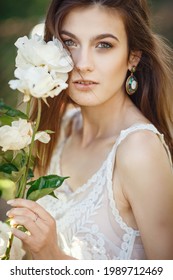 Beautiful Young Woman Gardening Outside In Summer Nature. Deeds And The Concept Of A Summer Outhouse, A Green Garden And Freedom