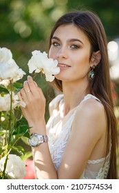 Beautiful Young Woman Gardening Outside In Summer Nature. Deeds And The Concept Of A Summer Outhouse, A Green Garden And Freedom