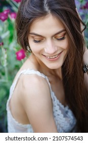 Beautiful Young Woman Gardening Outside In Summer Nature. Deeds And The Concept Of A Summer Outhouse, A Green Garden And Freedom