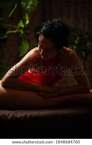 Beautiful young woman getting feet massage treatment at spa