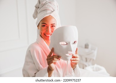 Beautiful young woman getting a led light therapy mask treatment  for her face at the beauty salon. - Shutterstock ID 2209975237