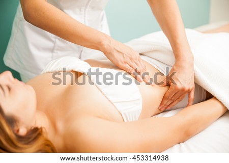 Beautiful young woman getting a lymphatic massage at a health and beauty spa