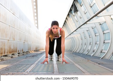 Beautiful Young Woman Getting Ready To Run On A Modern Bridge