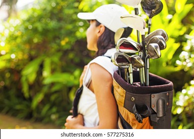 Beautiful young woman as a golf player (focus on equipment) - Powered by Shutterstock