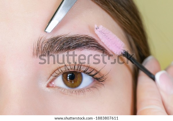 Beautiful young woman got correction of\
eyebrows in a beauty salon. eyebrow\
lamination