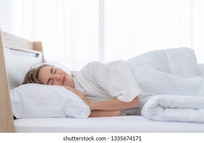 Beautiful young woman happy to sleeping in bed comfortably - Shutterstock ID 1335674171