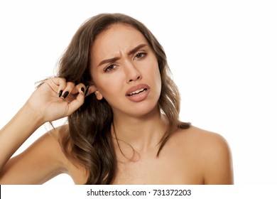 Beautiful Young Woman Has An Itch In Her Ear On White Background