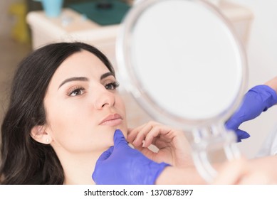 Beautiful young woman having aesthetic treatment in medical office, Corrective medicine concept
