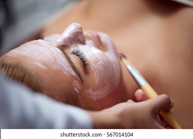 Beautiful young woman having a facial cosmetic treatment. - Shutterstock ID 567014104