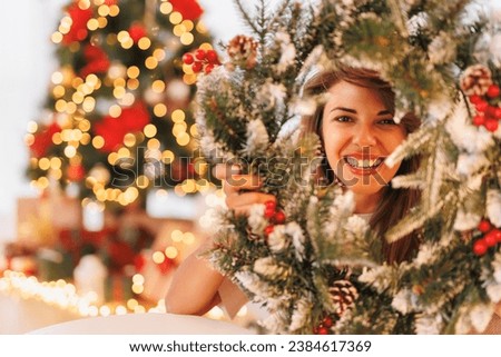 Similar – Image, Stock Photo Woman peeking through Christmas wrapping paper, festive mood