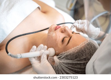 Beautiful young woman having Radio frequency skin tightening treatment in beauty clinic